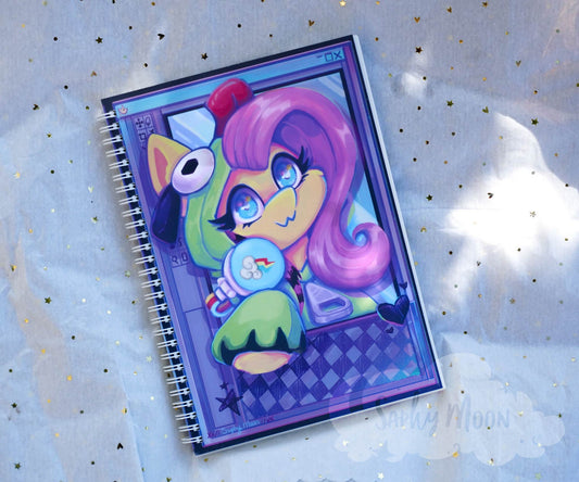 Notebook with a colorful character design on a light blue background