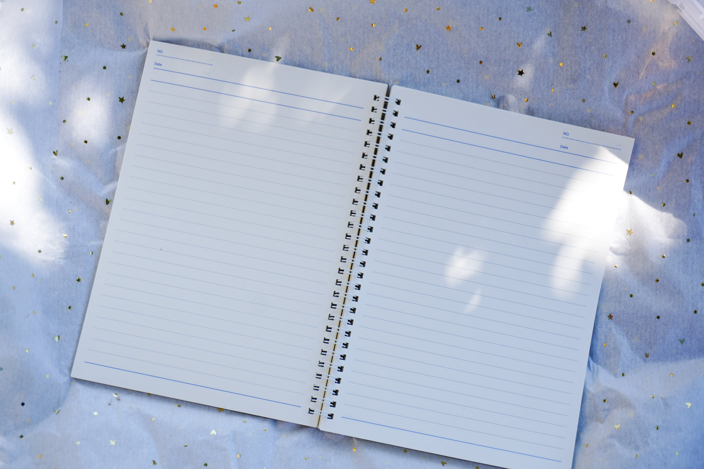 Open notebook with lined pages on a textured surface