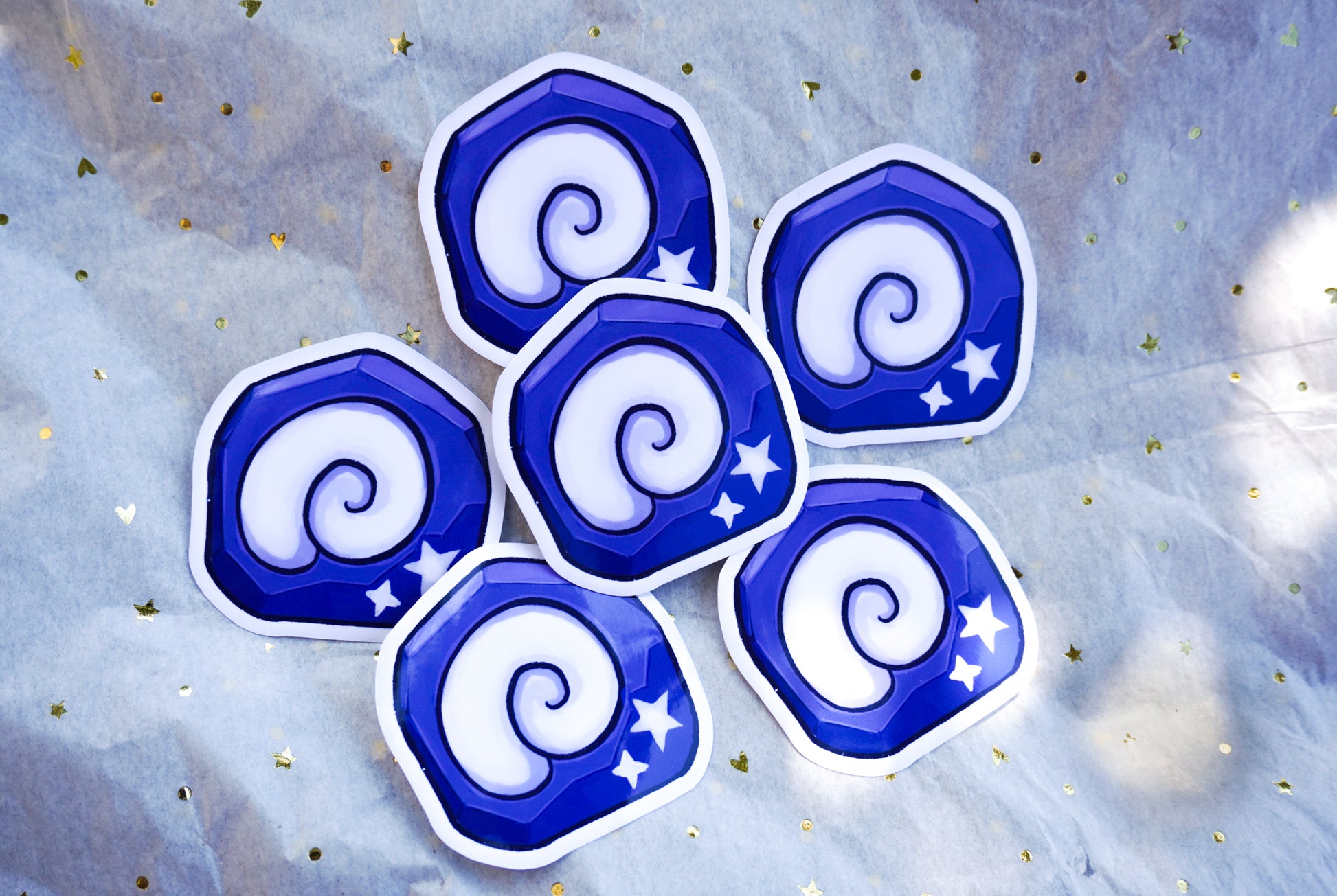 Set of blue and white spiral-shaped stickers on a starry background