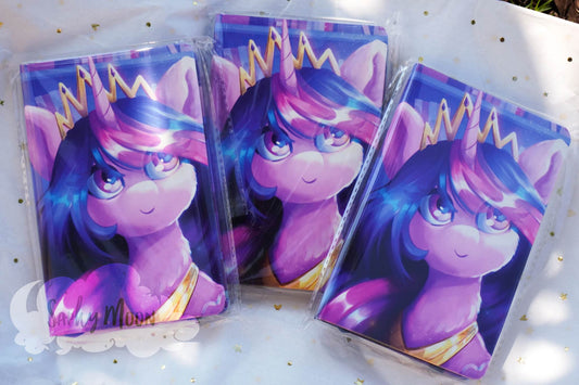 Three notebooks with purple unicorn on cover on a white surface.