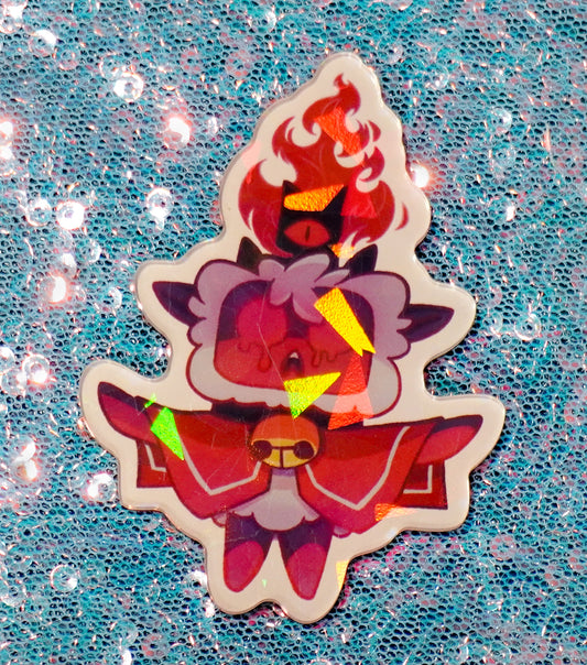 Small magnet of a lamb character with red and purple design on a glittery blue background