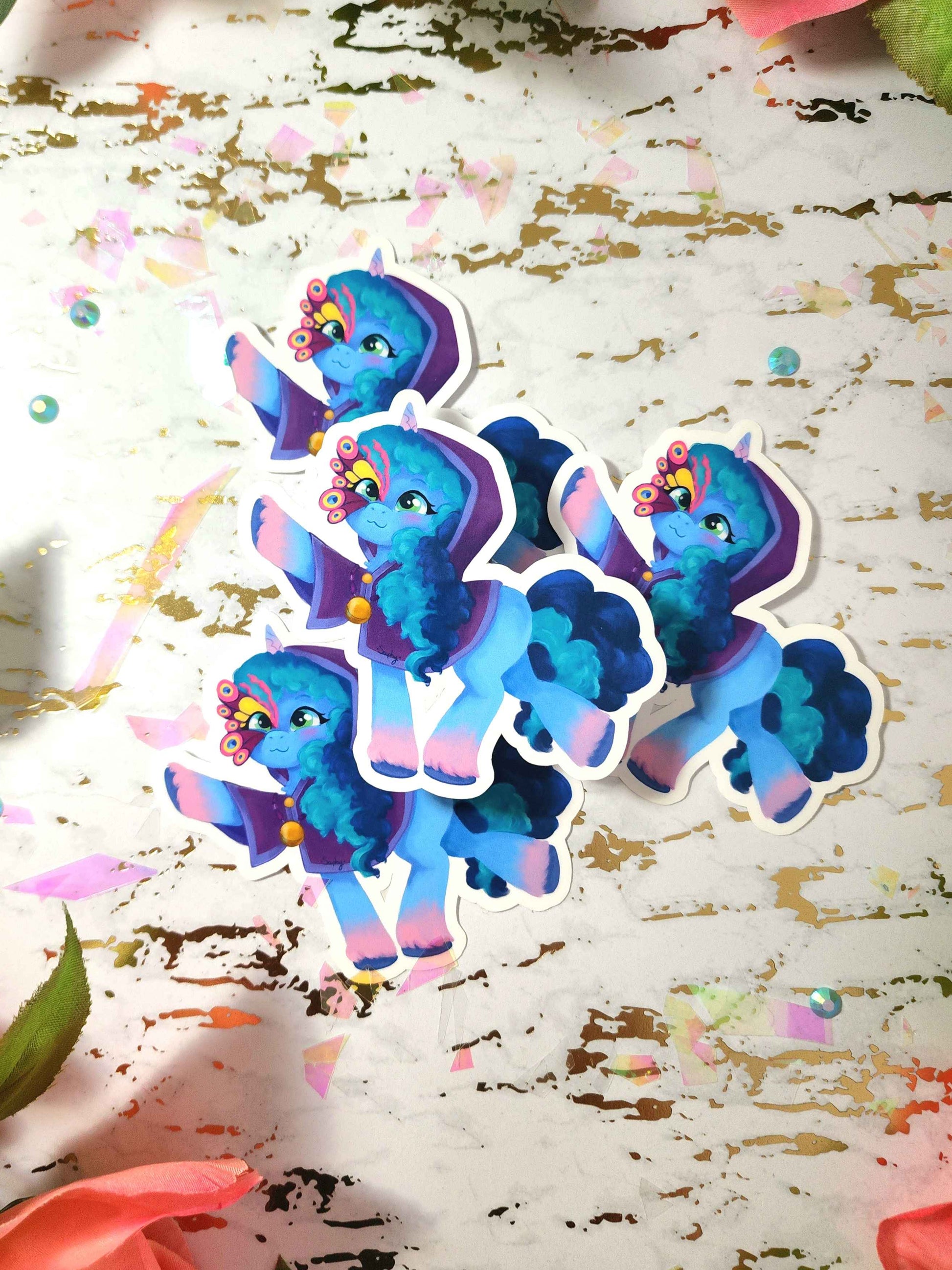 Colorful cartoon pony stickers on a textured surface with colorful confetti.