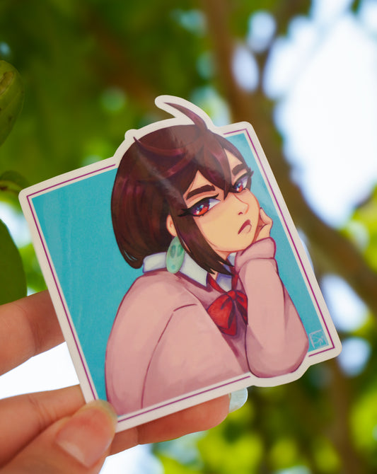 Sticker of an animated character held against a blurred natural background